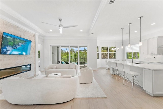 23 Ocean Ridge Blvd N, Palm Coast, FL 32137 - living area featuring ornamental molding, a ceiling fan, a fireplace, recessed lighting, and light wood-style floors