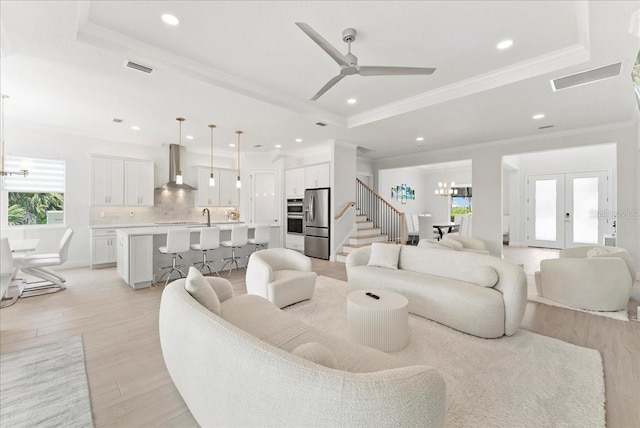 23 Ocean Ridge Blvd N, Palm Coast, FL 32137 - living area with a chandelier, a tray ceiling, light wood-type flooring, ornamental molding, and recessed lighting