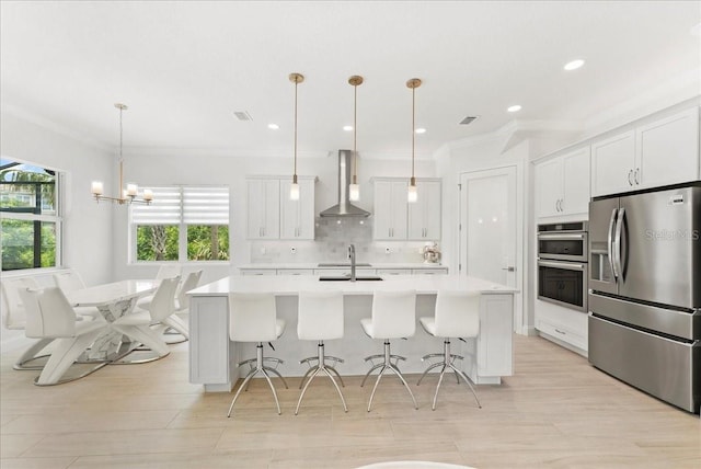 23 Ocean Ridge Blvd N, Palm Coast, FL 32137 - kitchen with stainless steel appliances, wall chimney exhaust hood, light countertops, crown molding, and a breakfast bar area