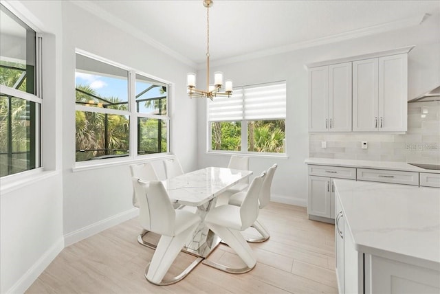 23 Ocean Ridge Blvd N, Palm Coast, FL 32137 - dining space featuring a chandelier, crown molding, and light wood-style flooring