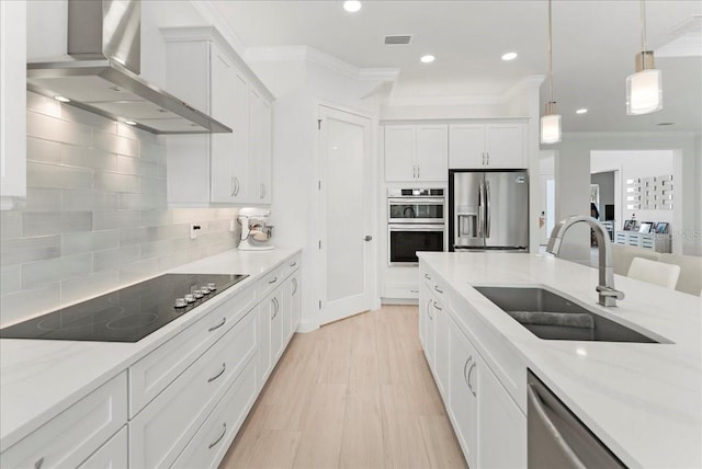 23 Ocean Ridge Blvd N, Palm Coast, FL 32137 - kitchen featuring stainless steel appliances, wall chimney exhaust hood, white cabinetry, recessed lighting, and decorative backsplash
