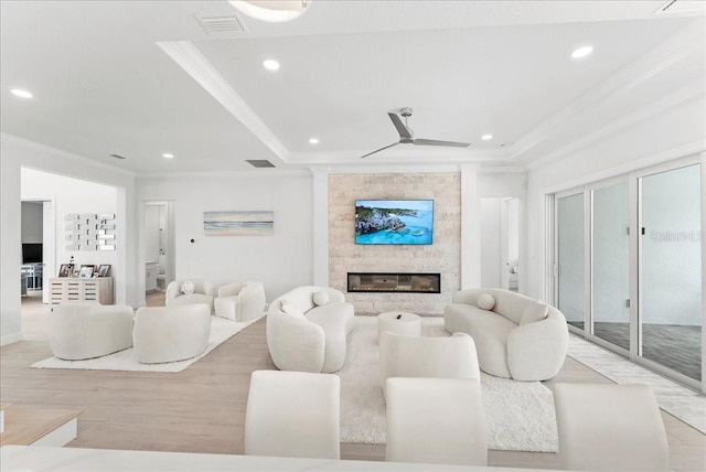 23 Ocean Ridge Blvd N, Palm Coast, FL 32137 - living room with crown molding, a large fireplace, recessed lighting, wood finished floors, and a tray ceiling