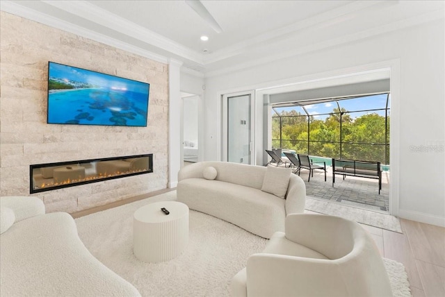 23 Ocean Ridge Blvd N, Palm Coast, FL 32137 - living area featuring crown molding, a large fireplace, wood finished floors, and a sunroom