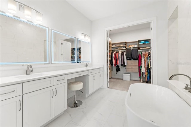 23 Ocean Ridge Blvd N, Palm Coast, FL 32137 - full bath featuring double vanity, a spacious closet, a freestanding tub, and marble finish floors