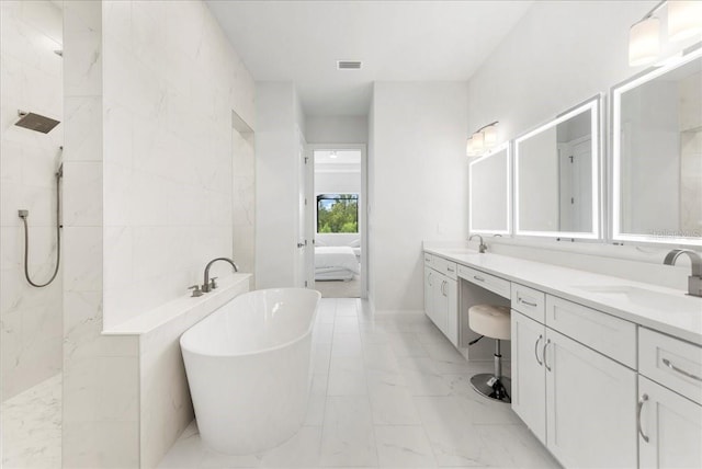 23 Ocean Ridge Blvd N, Palm Coast, FL 32137 - ensuite bathroom featuring a freestanding bath, double vanity, marble look tiles, a walk in shower, and tile walls