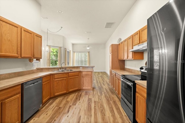 1707 Southern Belle Ln, Port Orange, FL 32128 - kitchen with appliances with stainless steel finishes, under cabinet range hood, light wood-style flooring, a peninsula, and light countertops
