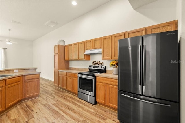 1707 Southern Belle Ln, Port Orange, FL 32128 - kitchen with appliances with stainless steel finishes, under cabinet range hood, light countertops, light wood-style flooring, and ceiling fan