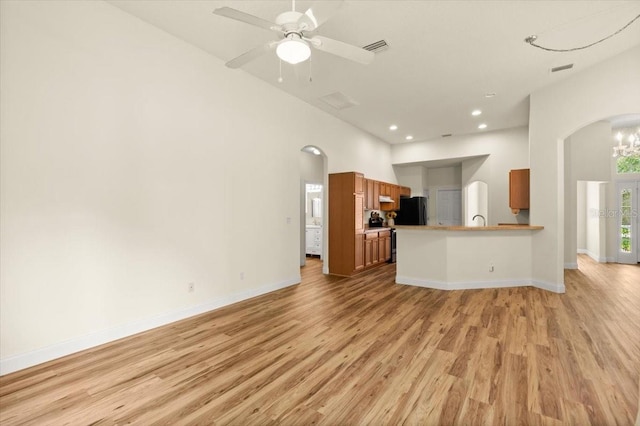 1707 Southern Belle Ln, Port Orange, FL 32128 - unfurnished living room with arched walkways, light wood-style flooring, recessed lighting, and a ceiling fan