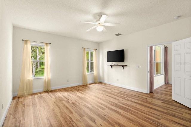 1707 Southern Belle Ln, Port Orange, FL 32128 - unfurnished room with light wood finished floors, a ceiling fan, a textured ceiling, and a smoke detector