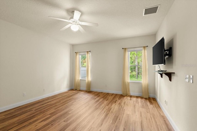 1707 Southern Belle Ln, Port Orange, FL 32128 - unfurnished room featuring light wood-type flooring, a textured ceiling, and a ceiling fan