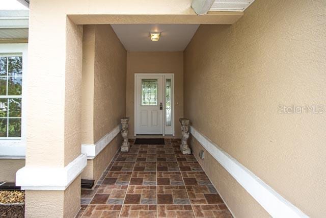 9 Empress Ln, Palm Coast, FL 32164 - property entrance with stucco siding