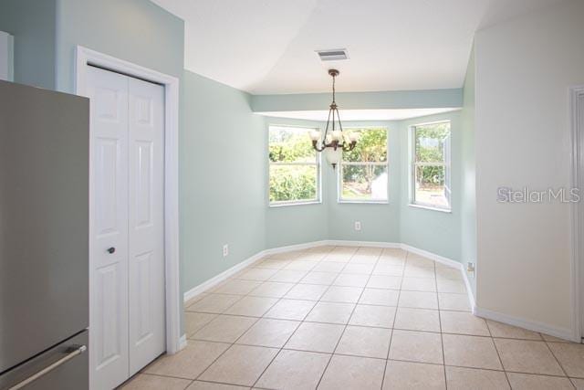 9 Empress Ln, Palm Coast, FL 32164 - unfurnished dining area with light tile patterned flooring and a chandelier