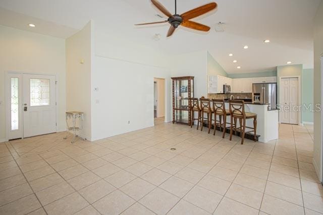 9 Empress Ln, Palm Coast, FL 32164 - living area featuring a ceiling fan, high vaulted ceiling, light tile patterned floors, and recessed lighting