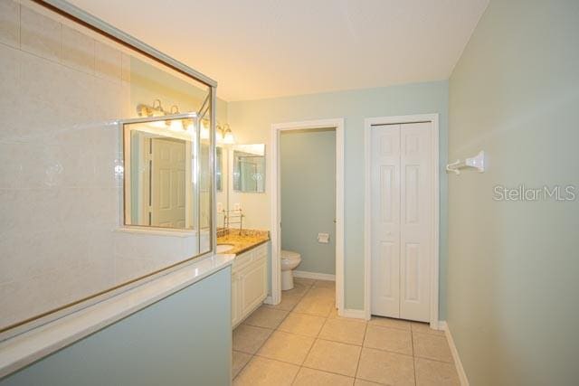 9 Empress Ln, Palm Coast, FL 32164 - bathroom featuring vanity, a closet, and tile patterned flooring