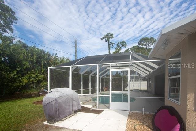 9 Empress Ln, Palm Coast, FL 32164 - view of patio featuring an outdoor pool, grilling area, and glass enclosure