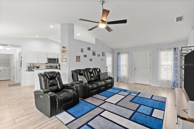 25 Round Mill Ln, Palm Coast, FL 32164 - living area featuring lofted ceiling, a ceiling fan, light wood-style floors, and washer / dryer