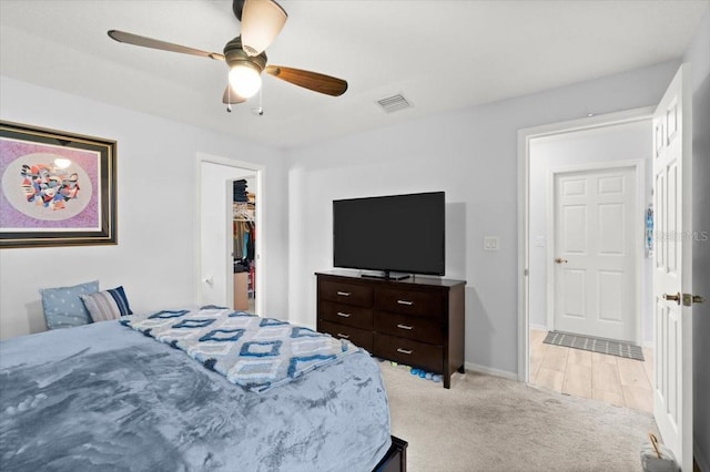25 Round Mill Ln, Palm Coast, FL 32164 - bedroom with light carpet, a walk in closet, and a ceiling fan