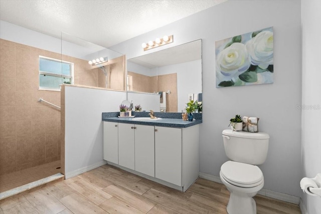 25 Round Mill Ln, Palm Coast, FL 32164 - full bathroom featuring vanity, wood finished floors, walk in shower, and a textured ceiling