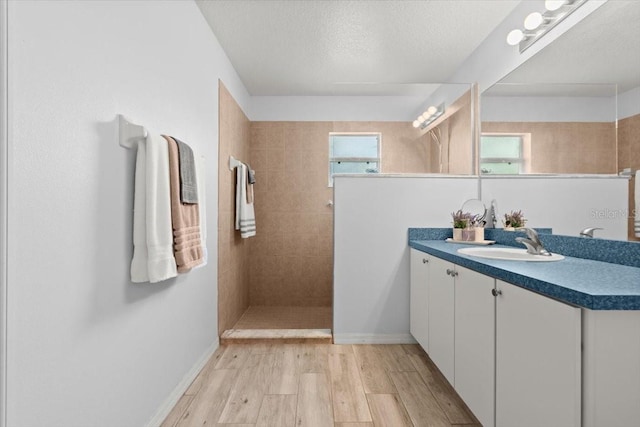 25 Round Mill Ln, Palm Coast, FL 32164 - full bath featuring vanity, a walk in shower, wood finished floors, and a textured ceiling