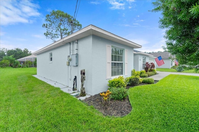 25 Round Mill Ln, Palm Coast, FL 32164 - view of property exterior featuring stucco siding and a yard