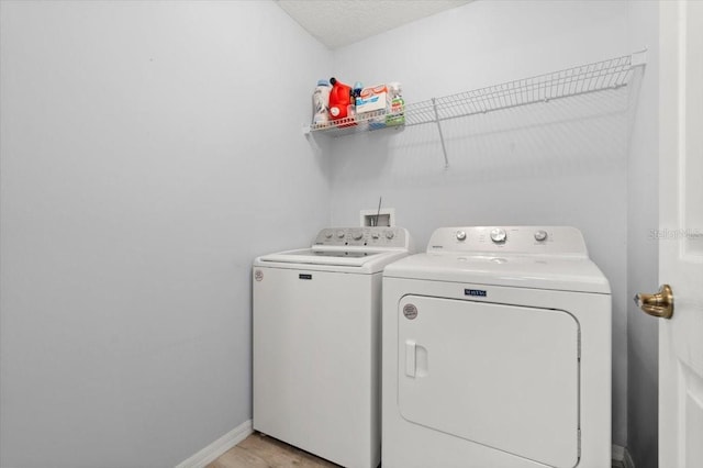 25 Round Mill Ln, Palm Coast, FL 32164 - laundry area featuring washing machine and clothes dryer and light wood-style floors