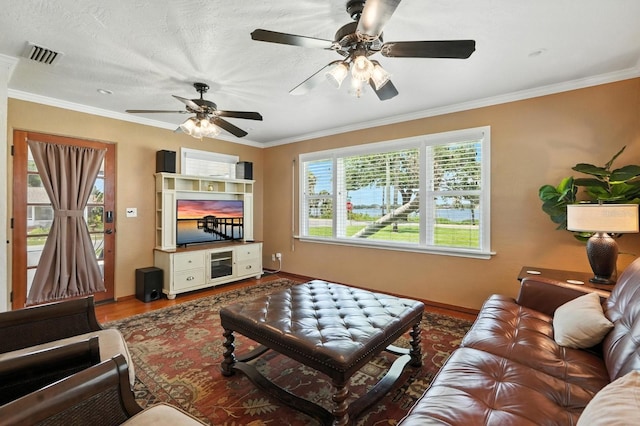 1146 Riverside Dr, Daytona Beach, FL 32117 - living area with wood finished floors, a ceiling fan, and crown molding