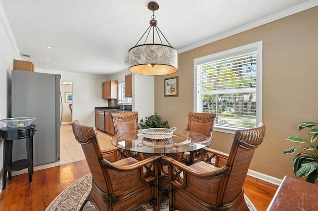 1146 Riverside Dr, Daytona Beach, FL 32117 - dining room with light wood finished floors, crown molding, and recessed lighting