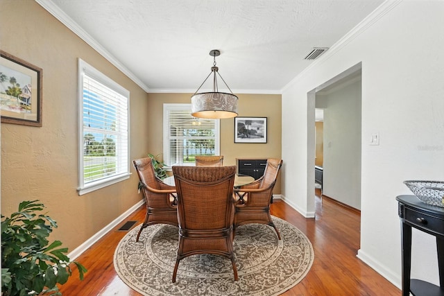 1146 Riverside Dr, Daytona Beach, FL 32117 - dining room featuring wood finished floors and ornamental molding