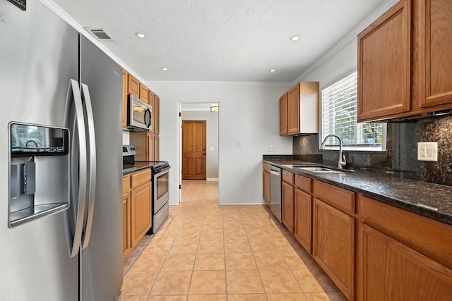 1146 Riverside Dr, Daytona Beach, FL 32117 - kitchen featuring stainless steel appliances, tasteful backsplash, brown cabinets, ornamental molding, and recessed lighting