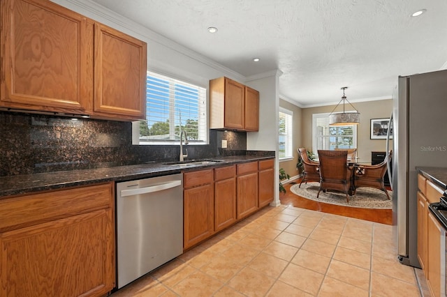 1146 Riverside Dr, Daytona Beach, FL 32117 - kitchen featuring appliances with stainless steel finishes, light tile patterned floors, ornamental molding, tasteful backsplash, and brown cabinets