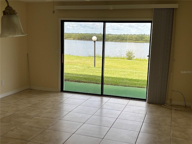 32 S Ocean Palm Villa Dr S Unit 320, Flagler Beach, FL 32136 - spare room featuring light tile patterned floors and a water view