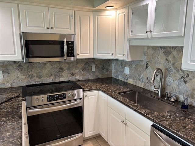 32 S Ocean Palm Villa Dr S Unit 320, Flagler Beach, FL 32136 - kitchen with stainless steel appliances, white cabinets, and tasteful backsplash