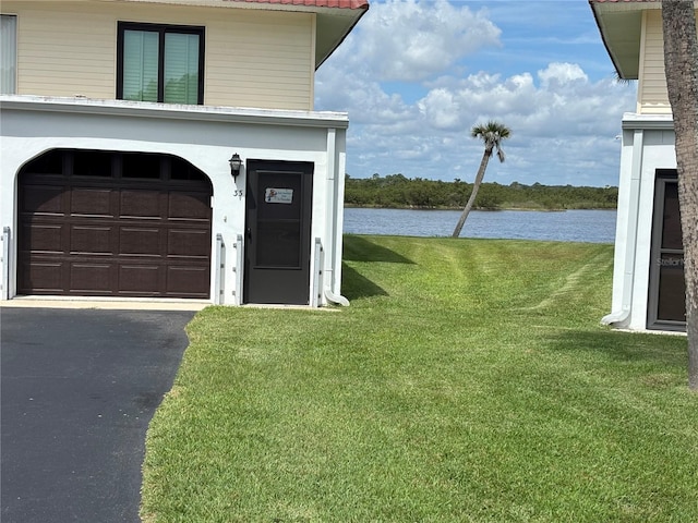 32 S Ocean Palm Villa Dr S Unit 320, Flagler Beach, FL 32136 - garage with a water view and asphalt driveway