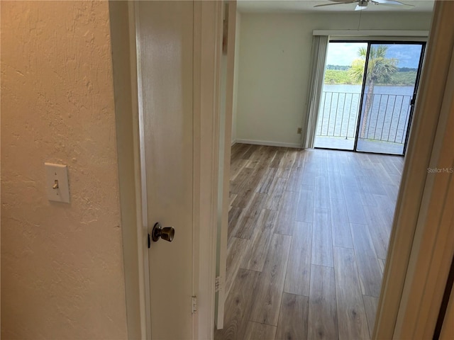 32 S Ocean Palm Villa Dr S Unit 320, Flagler Beach, FL 32136 - empty room with a textured wall, wood finished floors, and ceiling fan