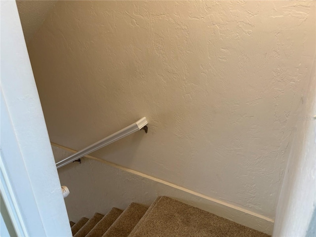 32 S Ocean Palm Villa Dr S Unit 320, Flagler Beach, FL 32136 - staircase with a textured wall