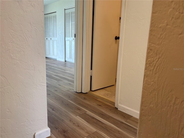 32 S Ocean Palm Villa Dr S Unit 320, Flagler Beach, FL 32136 - hallway featuring a textured wall and wood finished floors
