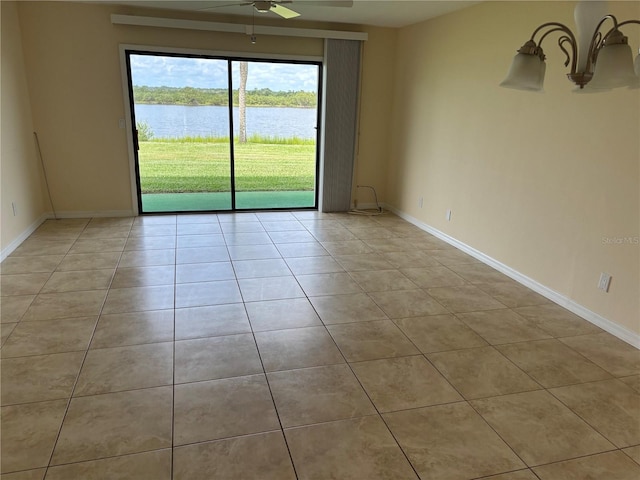 32 S Ocean Palm Villa Dr S Unit 320, Flagler Beach, FL 32136 - empty room with a ceiling fan, a water view, and light tile patterned floors