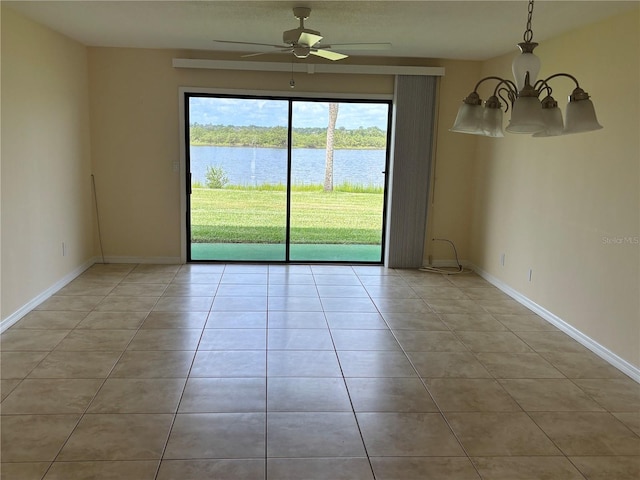 32 S Ocean Palm Villa Dr S Unit 320, Flagler Beach, FL 32136 - spare room featuring a water view, light tile patterned flooring, a ceiling fan, and a chandelier
