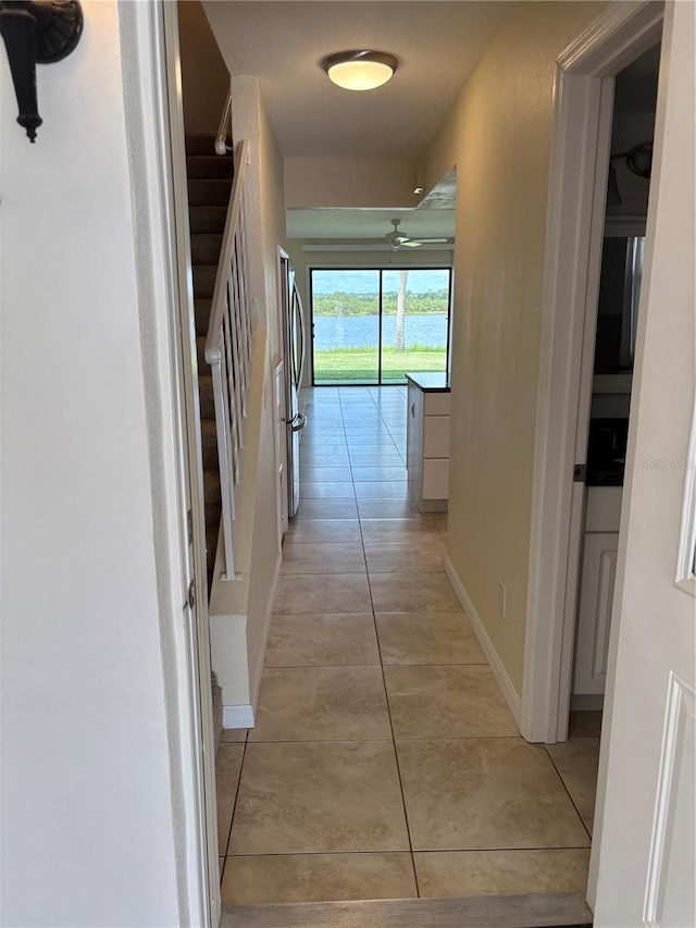 32 S Ocean Palm Villa Dr S Unit 320, Flagler Beach, FL 32136 - hall featuring light tile patterned flooring and stairs