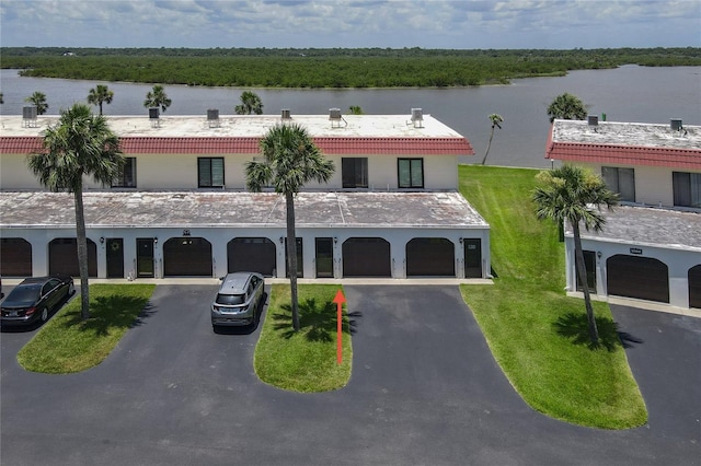 32 S Ocean Palm Villa Dr S Unit 320, Flagler Beach, FL 32136 - view of building exterior with driveway, a water view, and an attached garage