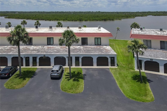 32 S Ocean Palm Villa Dr S Unit 320, Flagler Beach, FL 32136 - view of building exterior featuring driveway, a water view, and a garage