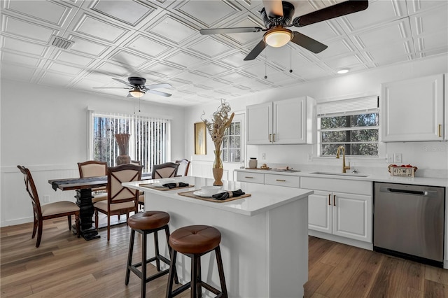 54221 Cravey Rd, Callahan, FL 32011 - kitchen featuring dishwasher, ceiling fan, an ornate ceiling, a kitchen bar, and light countertops