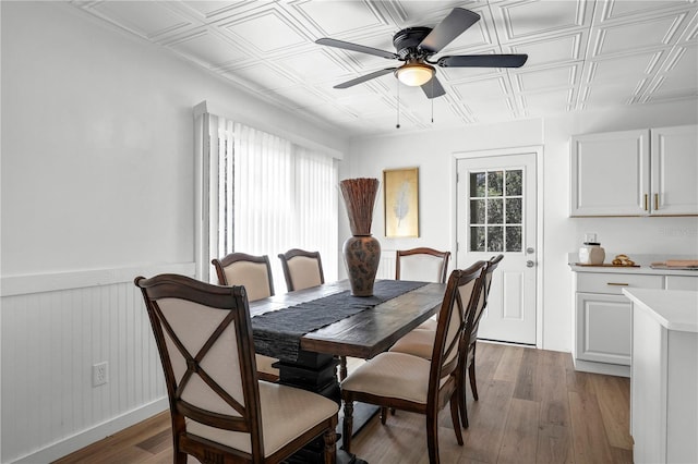 54221 Cravey Rd, Callahan, FL 32011 - dining space with an ornate ceiling, a ceiling fan, light wood-style flooring, and a wainscoted wall