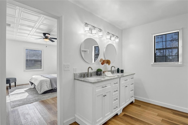 54221 Cravey Rd, Callahan, FL 32011 - bathroom featuring a ceiling fan, double vanity, and wood finished floors