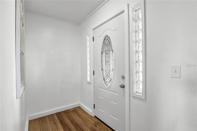54221 Cravey Rd, Callahan, FL 32011 - entryway featuring dark wood finished floors, crown molding, and healthy amount of natural light