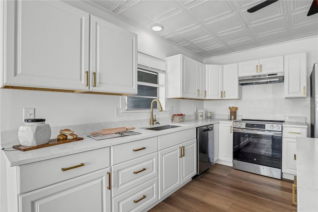 54221 Cravey Rd, Callahan, FL 32011 - kitchen with appliances with stainless steel finishes, an ornate ceiling, under cabinet range hood, white cabinets, and light countertops
