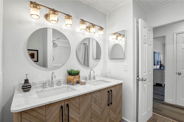 54221 Cravey Rd, Callahan, FL 32011 - bathroom featuring double vanity, wood finished floors, and ornamental molding