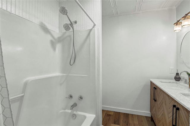 54221 Cravey Rd, Callahan, FL 32011 - bathroom with double vanity, wood finished floors, washtub / shower combination, and crown molding