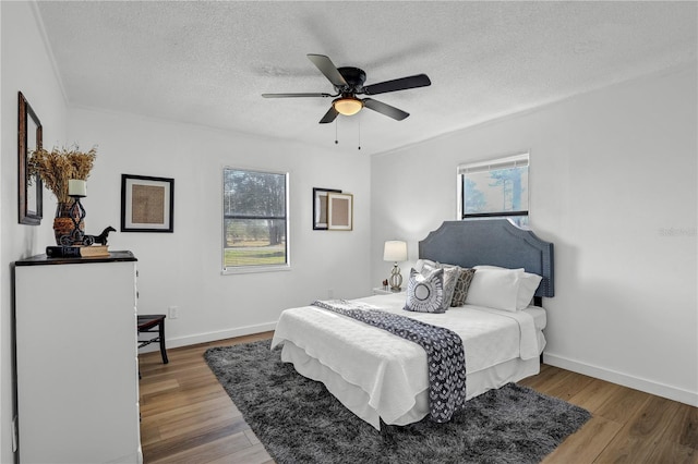 54221 Cravey Rd, Callahan, FL 32011 - bedroom featuring wood finished floors, a textured ceiling, and ceiling fan