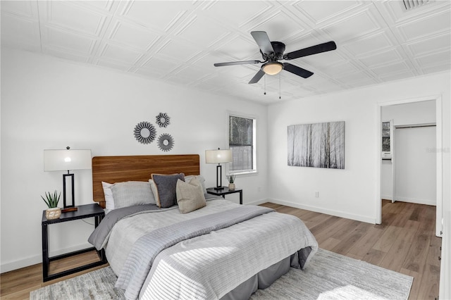 54221 Cravey Rd, Callahan, FL 32011 - bedroom with light wood-style flooring, an ornate ceiling, and ceiling fan